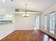 Open-concept living room with hardwood floors and french door access at 5327 Sw 89Th St, Ocala, FL 34476