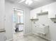 Bright laundry room featuring storage cabinets and sink at 5327 Sw 89Th St, Ocala, FL 34476
