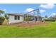 Spacious backyard featuring a screened-in patio area with well-maintained landscaping at 5331 Old Hickory Ln, Fruitland Park, FL 34731