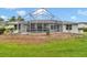 Large screened-in patio with a view of the backyard and well-manicured landscaping at 5331 Old Hickory Ln, Fruitland Park, FL 34731