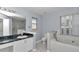 This bathroom has dual sinks, marble countertop, a toilet, shower and bathtub at 5331 Old Hickory Ln, Fruitland Park, FL 34731