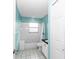Well-lit bathroom with turquoise walls, a tub, and a shower at 5331 Old Hickory Ln, Fruitland Park, FL 34731