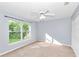 Sun-filled bedroom with ceiling fan, a large window and a closet at 5331 Old Hickory Ln, Fruitland Park, FL 34731