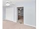 Bedroom features a ceiling fan, carpet, light blue walls and a built-in closet with double doors at 5331 Old Hickory Ln, Fruitland Park, FL 34731