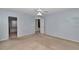 Bedroom features a ceiling fan, carpet, light blue walls and ensuite bath and toilet at 5331 Old Hickory Ln, Fruitland Park, FL 34731