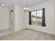Dining room featuring neutral walls, carpet, a chandelier and large window at 5331 Old Hickory Ln, Fruitland Park, FL 34731