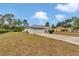 Wide shot of the property featuring a long concrete driveway and two-car garage at 5331 Old Hickory Ln, Fruitland Park, FL 34731