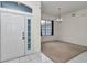 Foyer with front door, chandelier, tile floor, and view into adjacent room at 5331 Old Hickory Ln, Fruitland Park, FL 34731