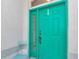 A close-up of a modern, bright green front door with window panel, handle, and peep hole at 5331 Old Hickory Ln, Fruitland Park, FL 34731