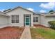 Inviting home with well-manicured lawn, tidy mulch beds, and a screened-in front porch at 5331 Old Hickory Ln, Fruitland Park, FL 34731