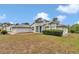 Charming home with a screen door, green bushes and a well-maintained lawn at 5331 Old Hickory Ln, Fruitland Park, FL 34731