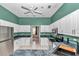 Kitchen with white cabinets, stainless steel appliances, green walls, and a ceiling fan at 5331 Old Hickory Ln, Fruitland Park, FL 34731