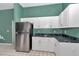 Kitchen featuring white cabinets, stainless steel fridge and granite countertops at 5331 Old Hickory Ln, Fruitland Park, FL 34731