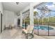 Cozy lanai with screened-in pool view, perfect for relaxation and enjoying the outdoors in comfort at 5331 Old Hickory Ln, Fruitland Park, FL 34731