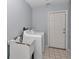 Functional laundry room with washer, dryer, and utility sink at 5331 Old Hickory Ln, Fruitland Park, FL 34731