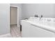 Spacious laundry area featuring a white washer and dryer setup at 5331 Old Hickory Ln, Fruitland Park, FL 34731