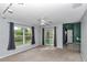Bright living room featuring large windows, sliding glass doors, and neutral carpeting at 5331 Old Hickory Ln, Fruitland Park, FL 34731
