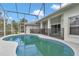 Inviting backyard pool area enclosed in a large screened in enclosure at 5331 Old Hickory Ln, Fruitland Park, FL 34731