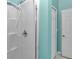 Bathroom shower stall with handheld shower head, textured walls, and updated fixtures at 5331 Old Hickory Ln, Fruitland Park, FL 34731