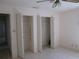 Bedroom with tile flooring and two closets with folding doors at 5355 Sw 31St St, Ocala, FL 34474