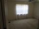 Bedroom with carpet, ceiling fan, and window bringing in natural light at 5355 Sw 31St St, Ocala, FL 34474