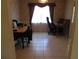 Tiled dining room featuring natural light and neutral-toned wallpaper, ideal for entertaining guests at 5355 Sw 31St St, Ocala, FL 34474