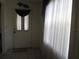 Welcoming entryway featuring tile flooring, decorative door accents, and sheer curtains for privacy at 5355 Sw 31St St, Ocala, FL 34474