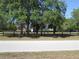Charming single story home with a well maintained lawn behind a black wooden fence at 5355 Sw 31St St, Ocala, FL 34474