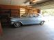 View of a vintage blue and white car stored in a well-organized garage with shelving at 5355 Sw 31St St, Ocala, FL 34474