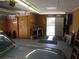 An organized garage featuring a workbench, storage shelves, and access to the outdoors at 5355 Sw 31St St, Ocala, FL 34474
