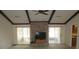 Inviting living room with exposed ceiling beams, brick fireplace, and sliding glass doors to a patio at 5355 Sw 31St St, Ocala, FL 34474