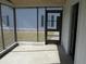 Screened-in porch featuring a concrete floor and views of the surrounding property at 5355 Sw 31St St, Ocala, FL 34474