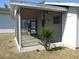 View of the screened porch that features a concrete floor and access to the backyard at 5355 Sw 31St St, Ocala, FL 34474