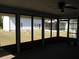 Spacious screened-in porch with multiple views of the surrounding yard at 5355 Sw 31St St, Ocala, FL 34474