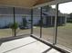 Spacious screened-in porch with concrete flooring, ideal for outdoor relaxation and entertaining at 5355 Sw 31St St, Ocala, FL 34474