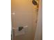 Shower features tile walls, adjustable shower head, and safety bar at 5355 Sw 31St St, Ocala, FL 34474