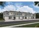 View of new two-story townhomes, showing garage, neutral paint, landscaping, and a bright sky at 6589 Sw 81St Loop, Ocala, FL 34476