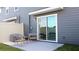 Outdoor patio area with modern furniture and a sliding glass door at 6589 Sw 81St Loop, Ocala, FL 34476