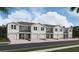 New two-story townhomes offer modern design and single-car garages under a partly cloudy sky at 6591 Sw 81St Loop, Ocala, FL 34476