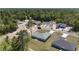 An aerial view of a home in a lushly landscaped neighborhood with sidewalks and paved streets at 6756 Sw 151St Loop, Ocala, FL 34473