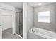 Luxurious bathroom with separate shower and tub, featuring modern tile and fixtures at 6756 Sw 151St Loop, Ocala, FL 34473