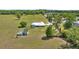 The home is surrounded by a lush landscape and includes a pool and barn at 719 Ne 39Th St, Ocala, FL 34479
