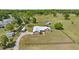 Expansive aerial view of a well-maintained home with ample yard space, mature trees, and a long driveway at 719 Ne 39Th St, Ocala, FL 34479