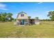 Exterior of a quaint barn featuring a charming white porch and a functional lean-to at 719 Ne 39Th St, Ocala, FL 34479