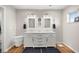 Bright bathroom with double vanity, modern fixtures, and wood-look floors at 719 Ne 39Th St, Ocala, FL 34479