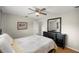 Comfortable bedroom with dark furniture, a ceiling fan, and a large mirror, creating a relaxing and stylish space at 719 Ne 39Th St, Ocala, FL 34479