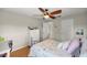 Cozy bedroom with a metal bed frame, light wood flooring, and a double door closet, creating a functional and inviting space at 719 Ne 39Th St, Ocala, FL 34479