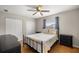 Cozy bedroom featuring a queen-sized bed, wood-look flooring, two closets, and a ceiling fan for optimal comfort at 719 Ne 39Th St, Ocala, FL 34479