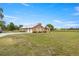 View of the home and the expansive, lush green lawn and fence at 719 Ne 39Th St, Ocala, FL 34479