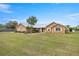 Charming single-story home with a sprawling lawn and white-trimmed windows and a metal roof at 719 Ne 39Th St, Ocala, FL 34479